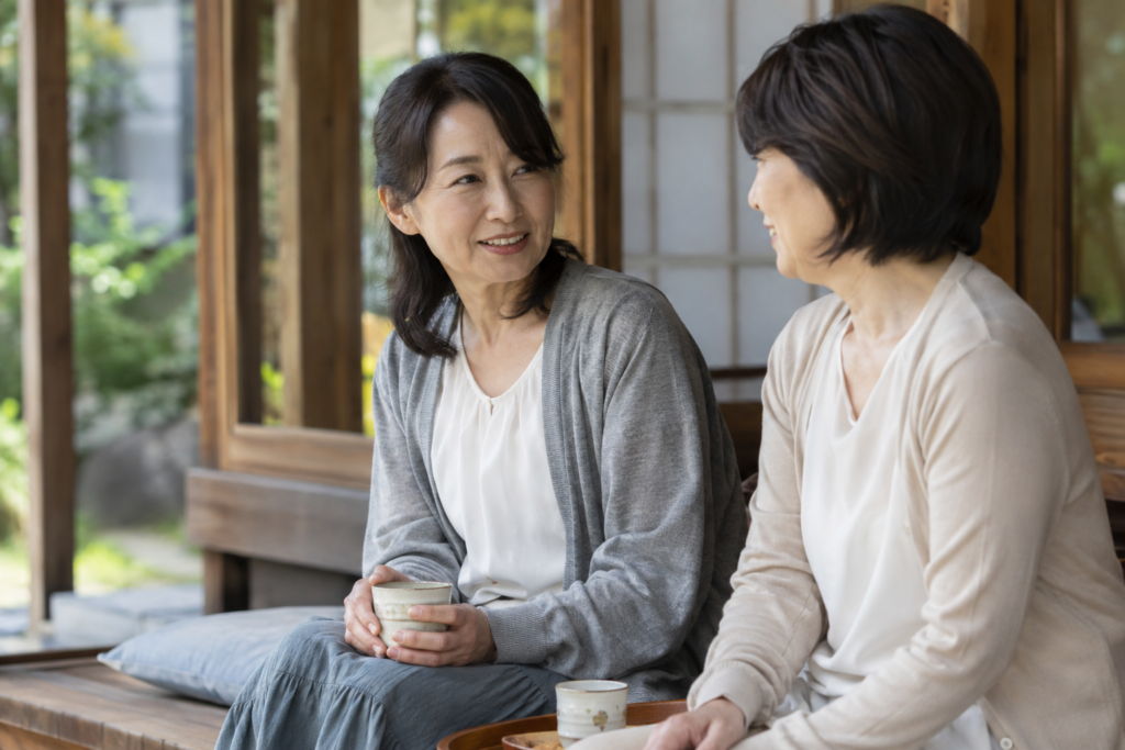 Two women sitting together on a quiet veranda